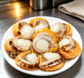 Steamed abalone in the shell with golden broth